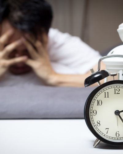 asian man in bed suffering insomnia and sleep disorder thinking about his problem at night